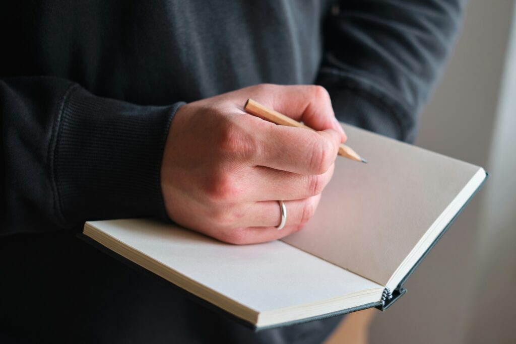 man with notebook and pencil